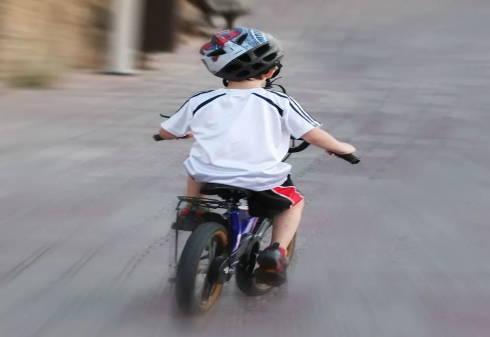 Copil de 10 ani pe bicicletă, acoșat de o mașină